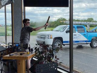 Professional window cleaner washing glass pane in commercial building